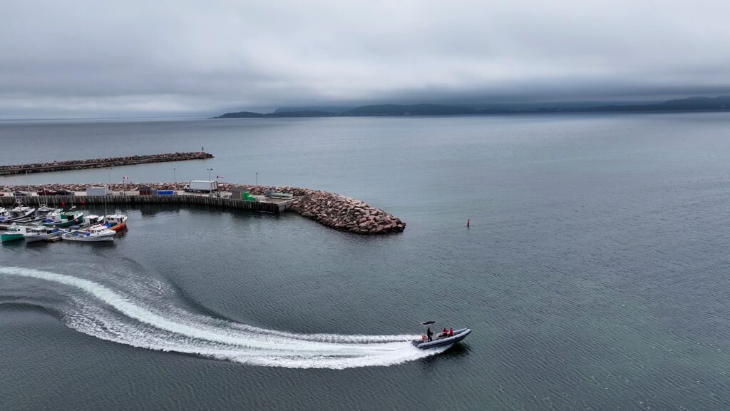 A zodiac leaves the dock at Ingonish Harbour