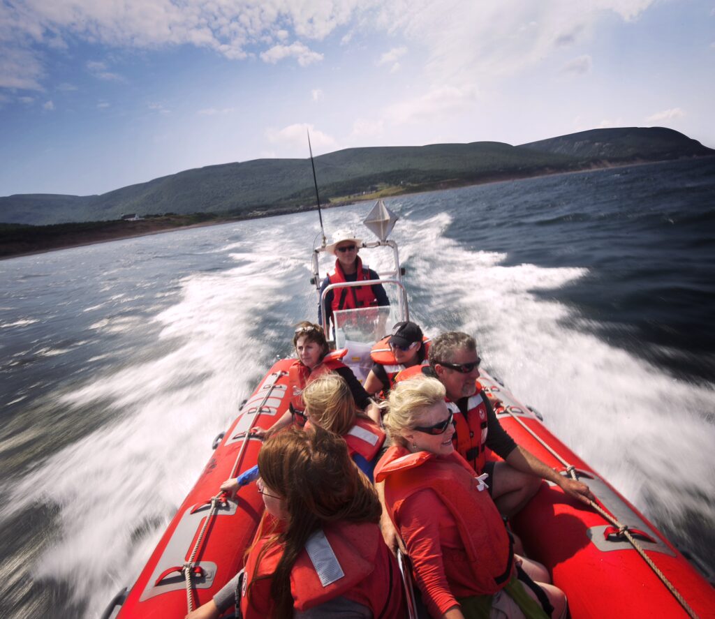 A zodiac speeds past Pleasant Bay