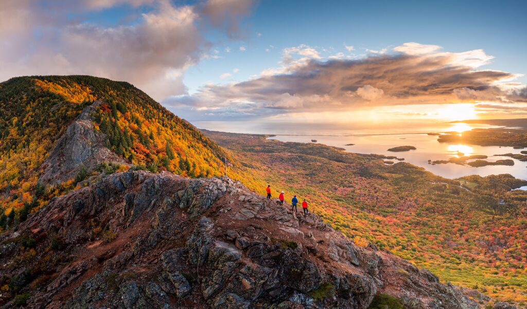 Hikers watch the sunrise from tenerife mountain in the fall