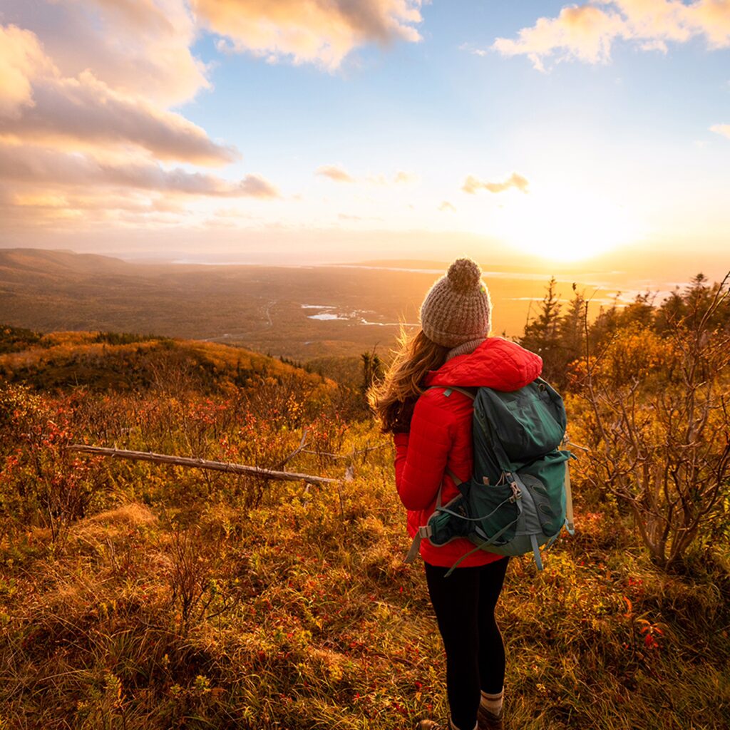 a hiker on acadian trail in fall