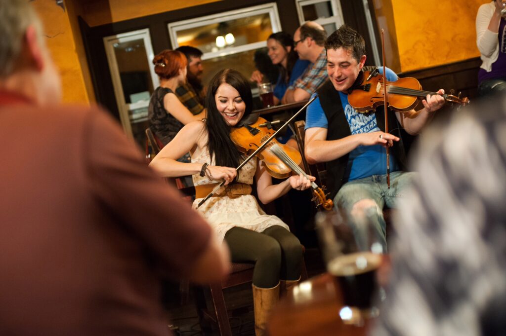 a ceilidh in a pub with fiddlers