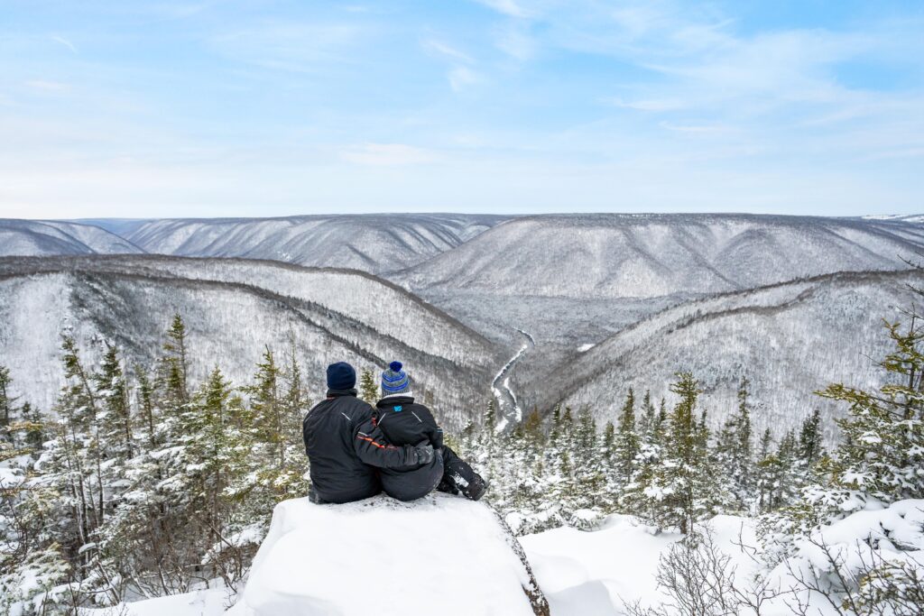 two people hug with a scenic vista in the background